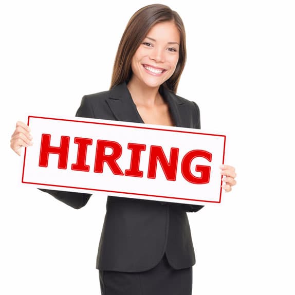 women holding a hiring sign